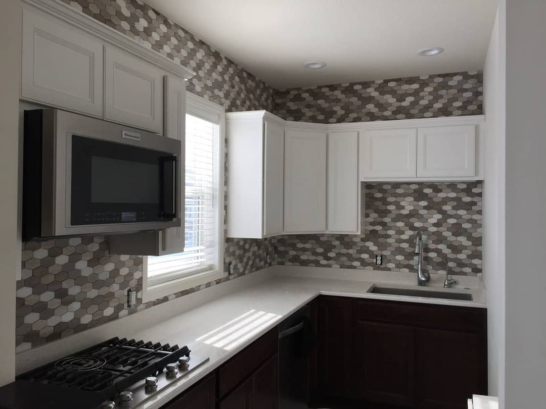 picture of a newly remodeled kitchen with custom backsplash and tile