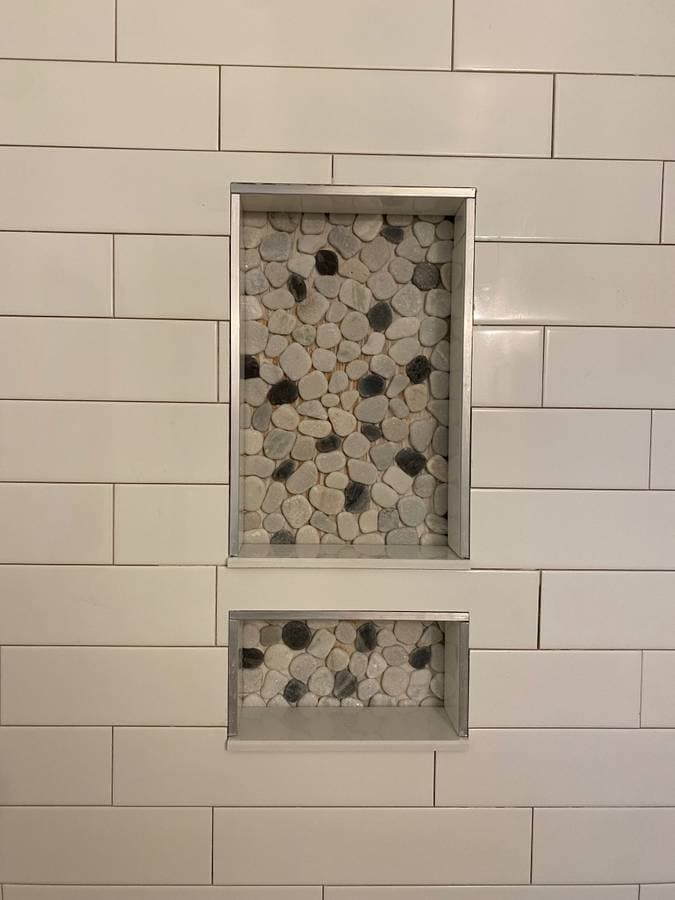 picture of a recently tiled bathroom shower with custom tile backsplash