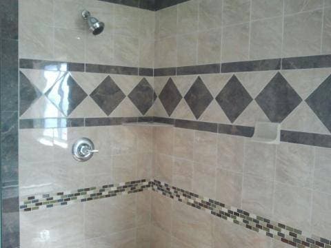 picture of custom tile backsplash and flooring in a remodeled shower